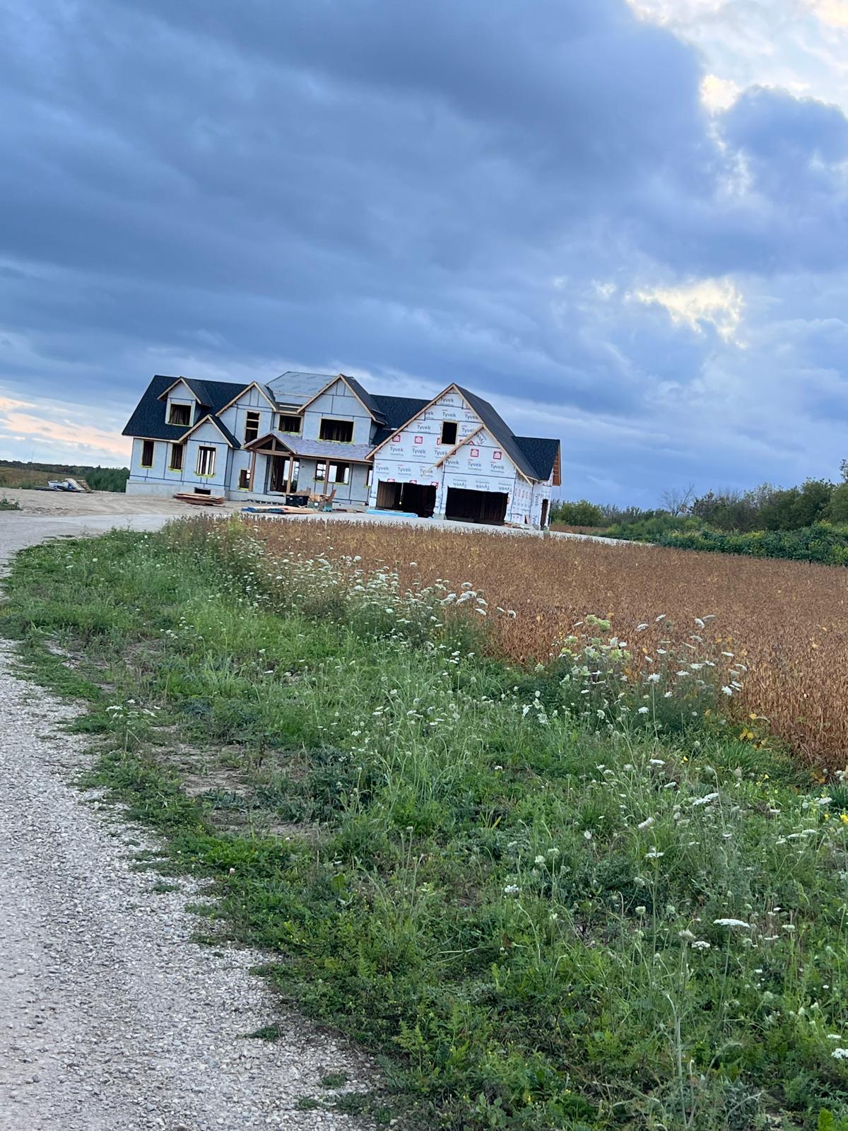 Large new construction home with completed shingle roof