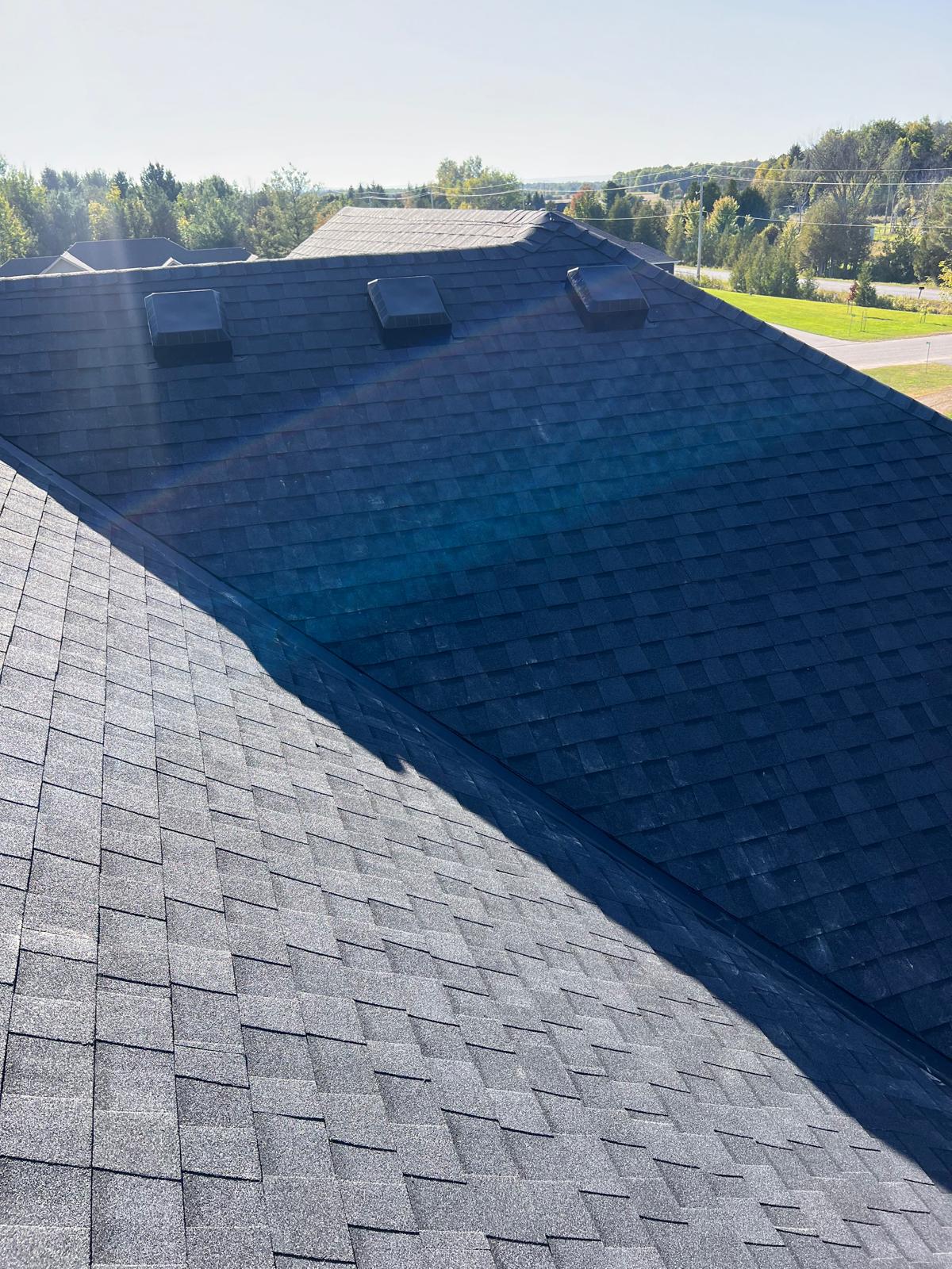Completed charcoal shingle roof with ventilation — GTA